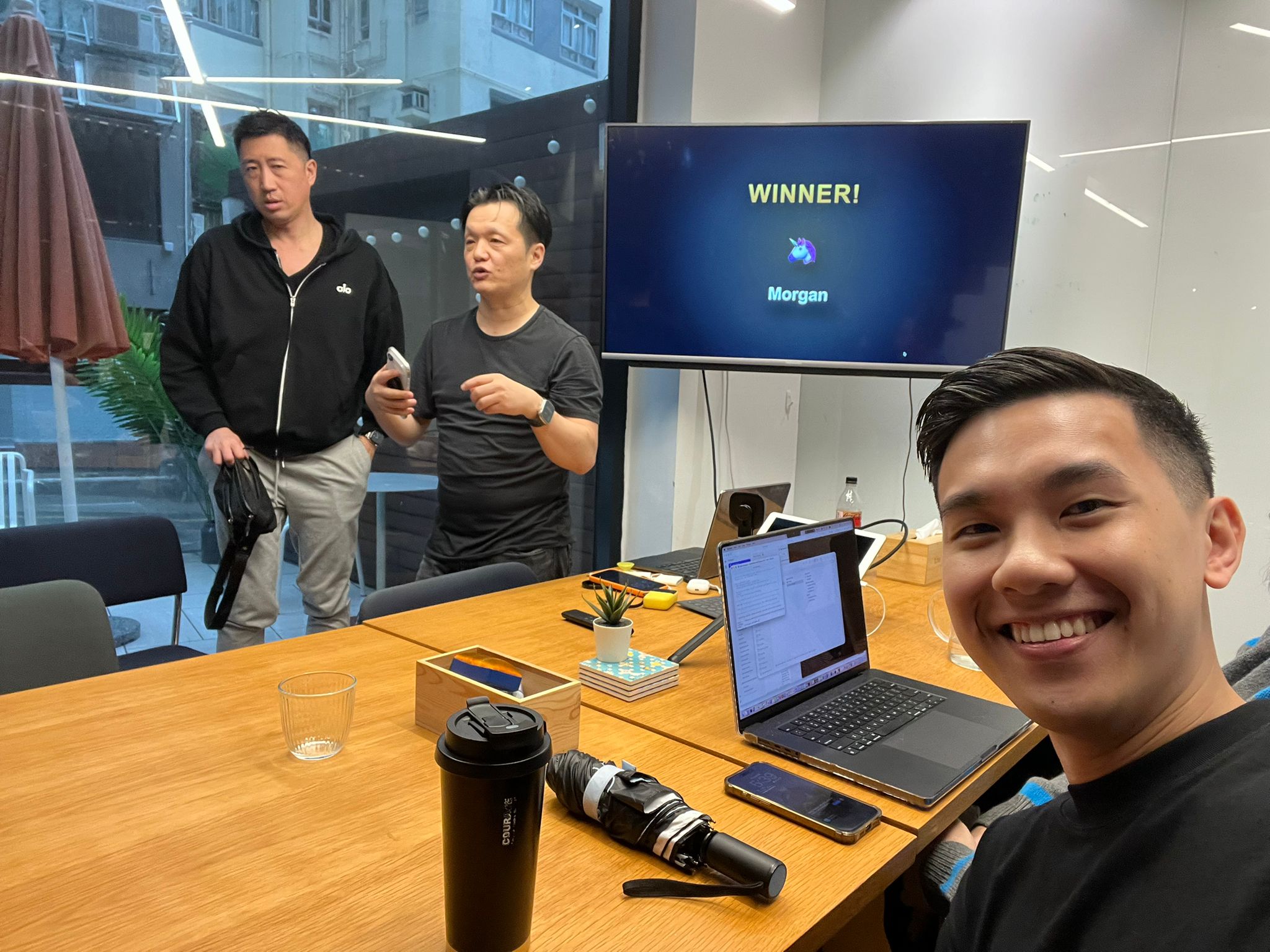 Selfie after the event with Lucky Drop winner screen visible in background